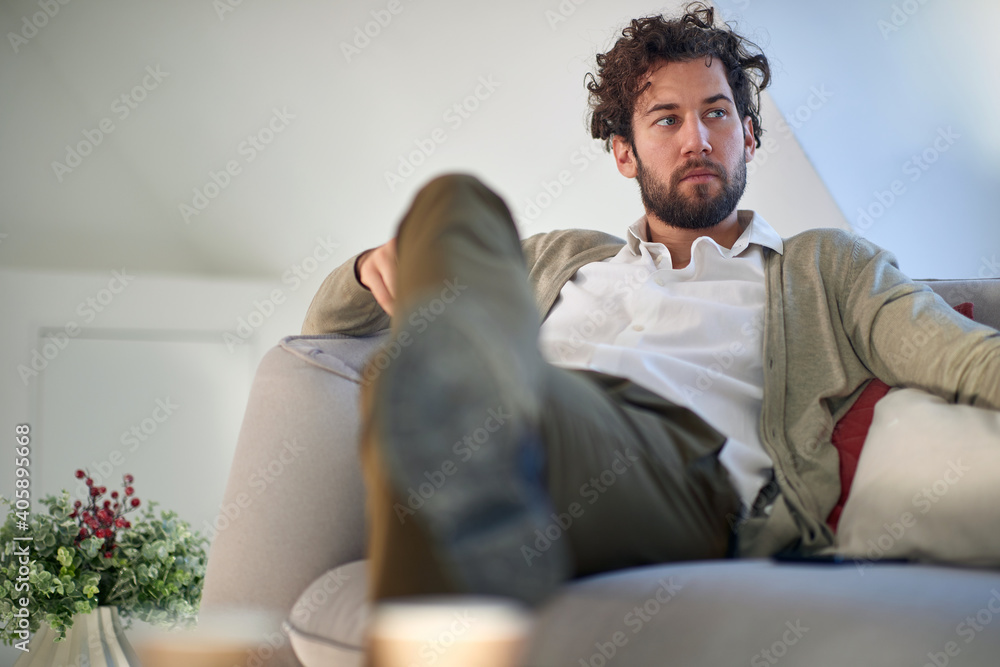 A young handsome man relaxed on the couch. Home, leisure A young handsome man relaxed on the couch. Home, leisure