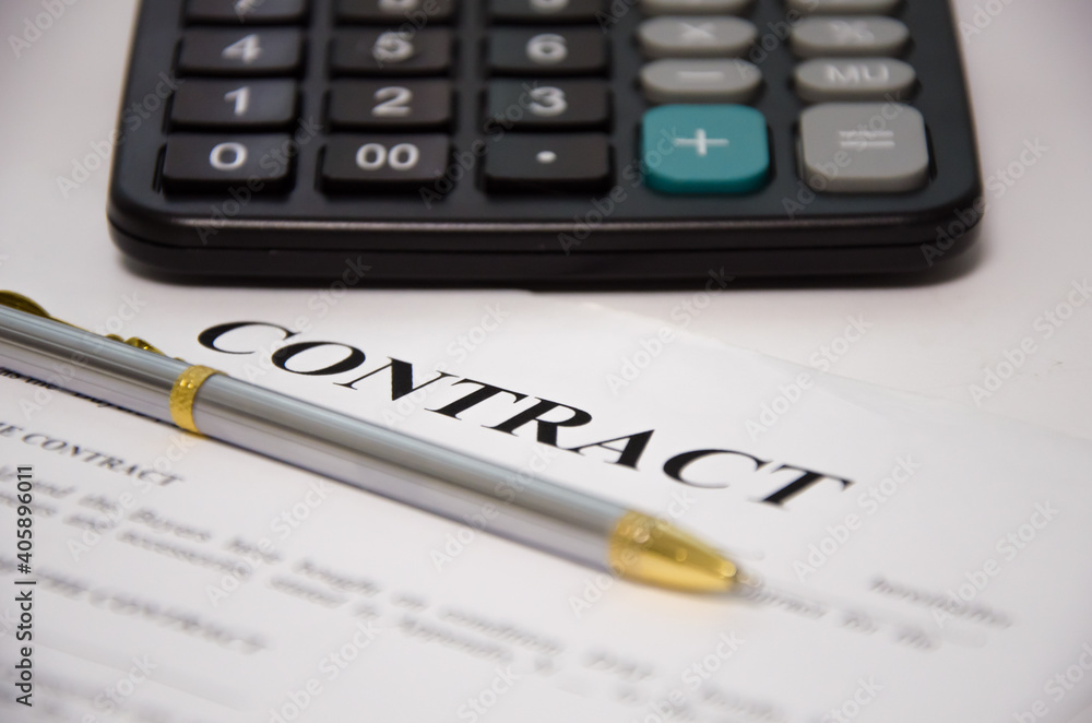 contract pen and calculator lie on a white background. sign contract. contract pen and calculator lie on a white background. sign contract.