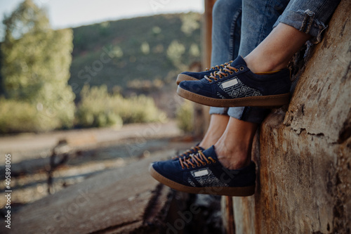 Image of a couple's feet sitting down.