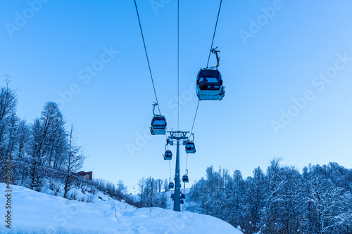 Lift cabins in a mountain ski resort snowy slope in a winter