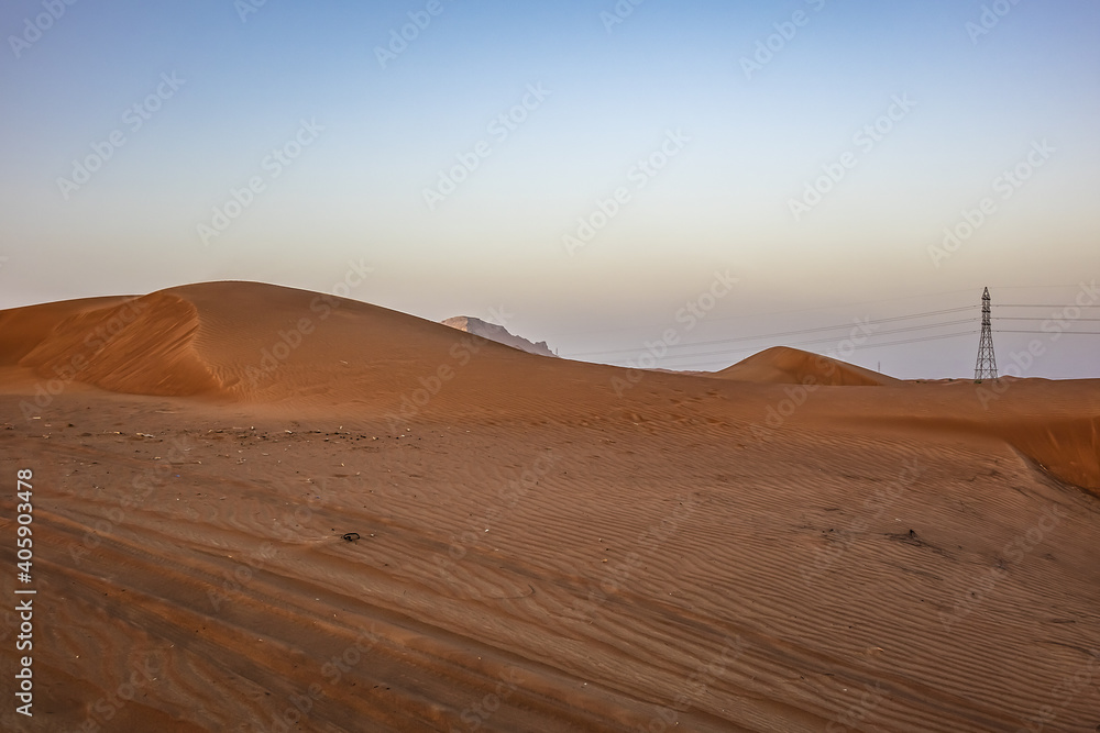 Desert dunes near Dubai at sunset light. Dubai, United Arab Emirates, Middle East.