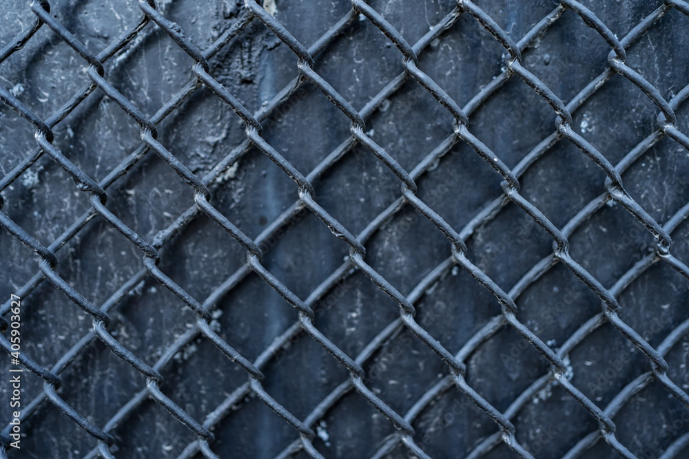 Old black metal background covered with wire mesh grille. Metal texture Old black metal background covered with wire mesh grille. Metal texture