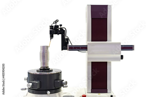 Machining cylindrical metal part set on work turntable on roundness cylindricity and straightness measuring tester machine and during inspection