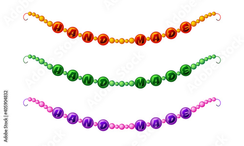 Set of three different colored beads with the inscription Hand Made on white background	