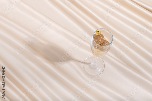 Fototapet Creative minimal concept made of champaign glass and Christmas baubles on pastel