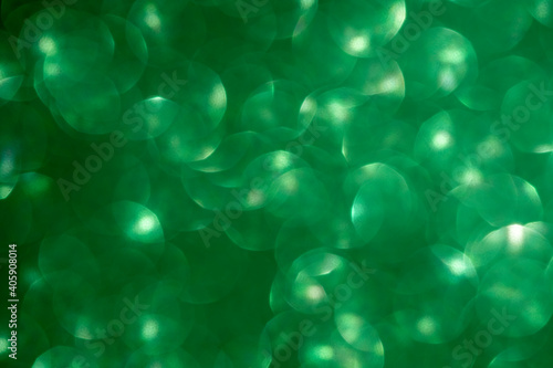 Green glitter vintage lights background. Defocused. Close-up