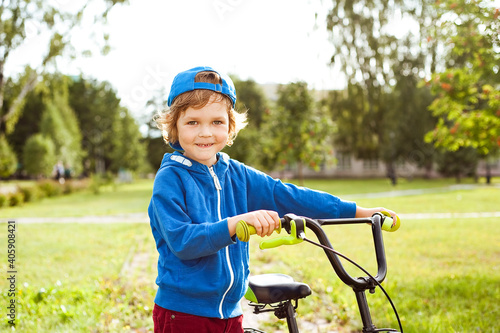 Portrait of a cute boy with a Bicycle.