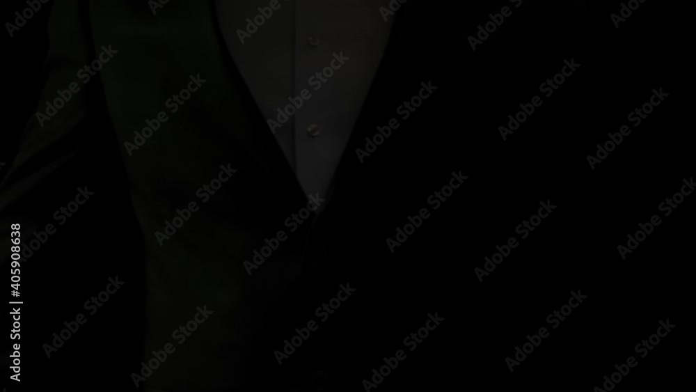 Businessman leader in a suit manipulates the strings of puppets tied to his fingers. Domination, power and submission concept. Close up mans hands illuminated with colored lights. Slow motion. Businessman leader in a suit manipulates the strings of puppets tied to his fingers. Domination, power and submission concept. Close up mans hands illuminated with colored lights. Slow motion.