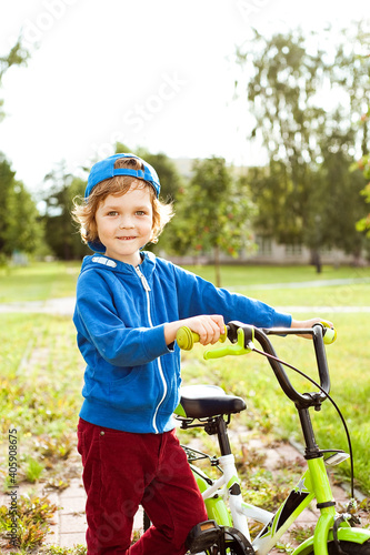 Portrait of a cute boy with a Bicycle.