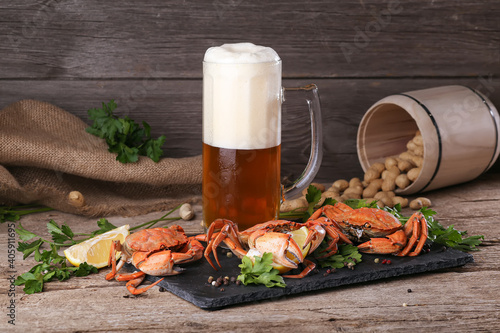 Mug of beer with crabs on a wooden surface