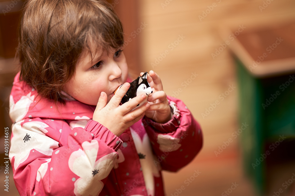 Pottery workshop. A little girl blows a ceramic whistle made in the form of a husky dog. Selective focus. Copy space. Pottery workshop. A little girl blows a ceramic whistle made in the form of a husky dog. Selective focus. Copy space.