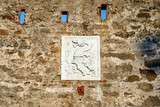 Coat of arms of the Appiani family at the entrance of the medieval town of Populonia,  municipality of Piombino, Tuscany, Italy.