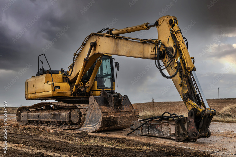 Excavator with hydraulic hammer on road construction works Excavator with hydraulic hammer on road construction works