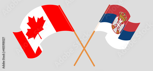 Crossed and waving flags of Canada and Serbia