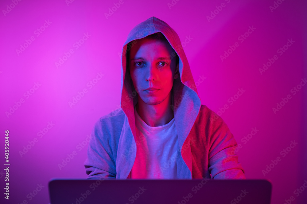 Gamer plays on a laptop. The programmer writes the code. Man on a colored background Gamer plays on a laptop. The programmer writes the code. Man on a colored background