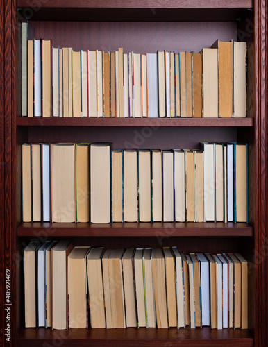 Bookshelf with books displayed backwards.
