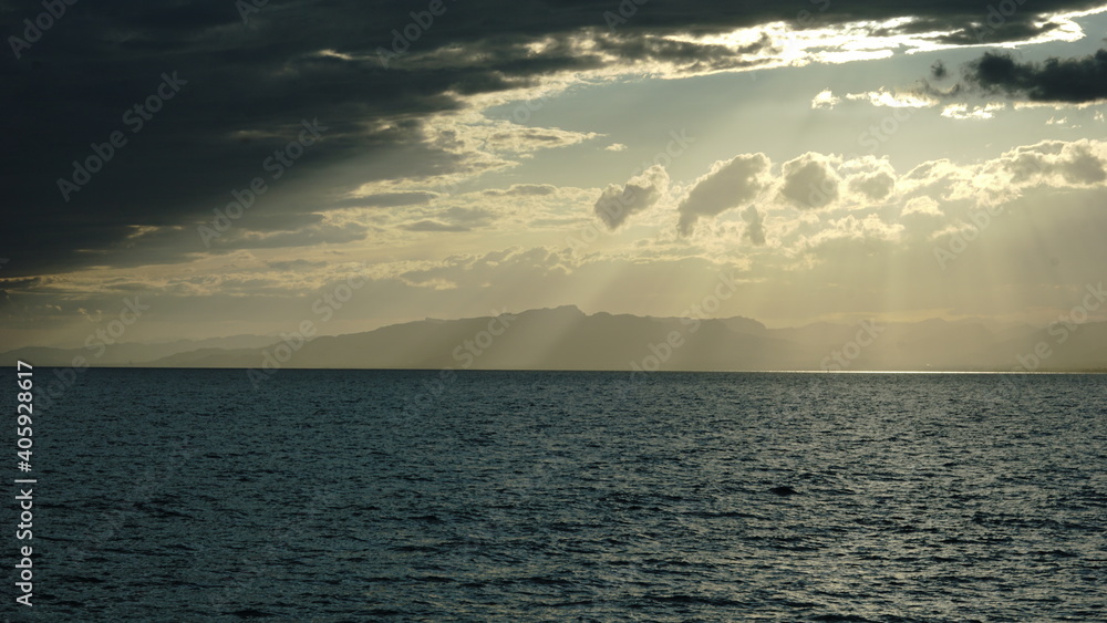 sunbeams over the sea against the cloud