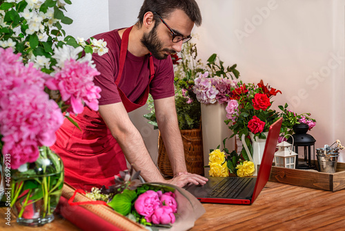 Crop view saller of flowers. Floristic business. Arrangement of bouquets. photo