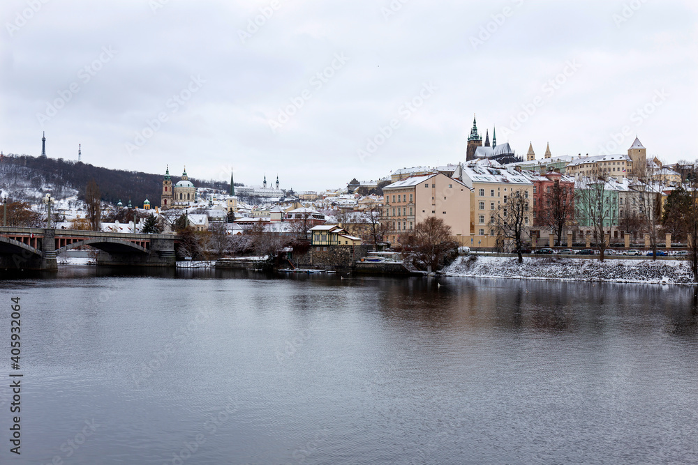 Snowy Prague Lesser Town with Prague Castle above River Vltava, Czech republic