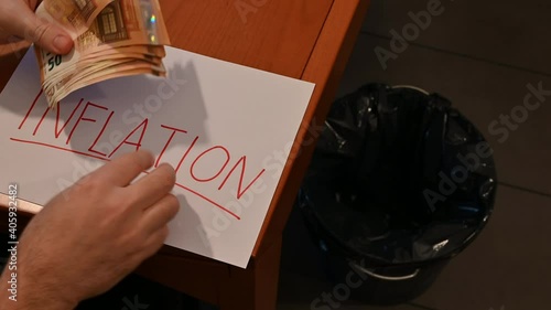 Wallpaper Mural Conceptual image of inflation: the inscription inflation on the white sheet foretells the loss of value of money, the 50 euro bills are rolled up and thrown into the garbage can. Torontodigital.ca