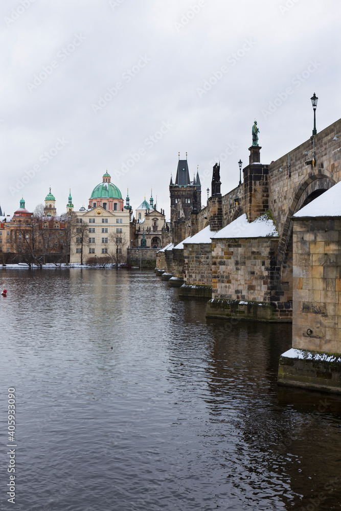 Fototapeta premium Snowy Prague Old Town with Charles Bridge above River Vltava, Czech republic