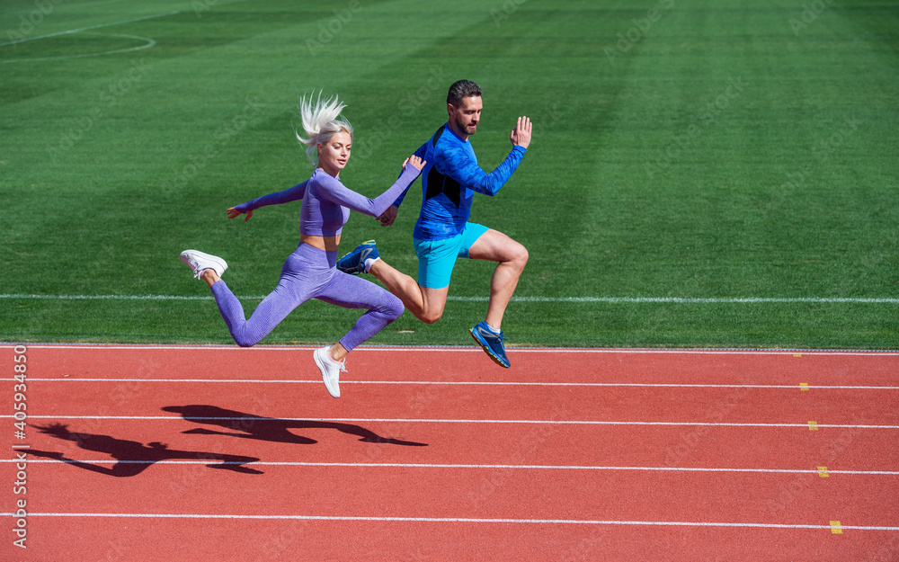 Obraz premium energy stamina. fit sporty people jumping. man and woman sport trainer run. fitness couple training outdoor. runners on running track. challenge and competition. endurance