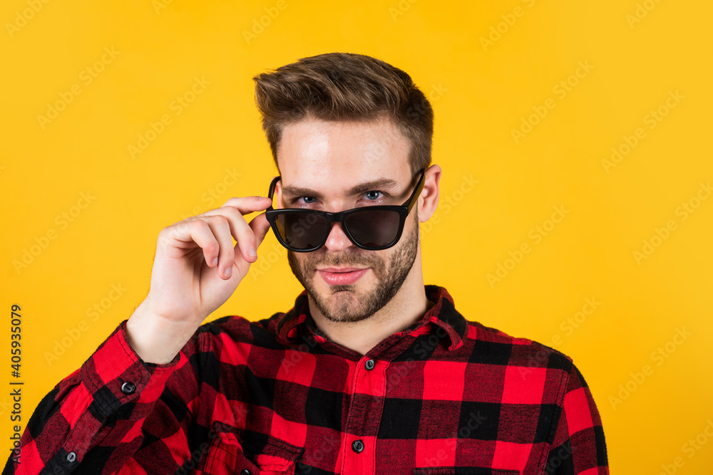 I see you. mens wear. young handsome guy in checkered shirt and glasses. stylish male wear casual clothes. bearded man with bristle on unshaven face. fashion and beauty. barbershop concept I see you. mens wear. young handsome guy in checkered shirt and glasses. stylish male wear casual clothes. bearded man with bristle on unshaven face. fashion and beauty. barbershop concept