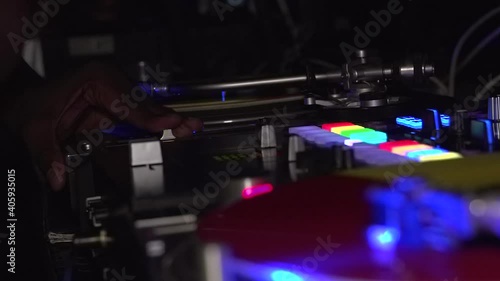 Nightclub DJ playing electronic music and scratching