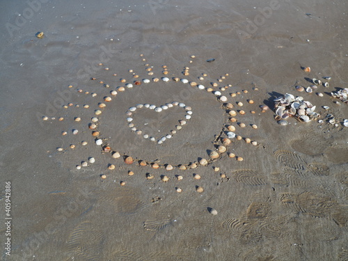 heart made of shells on sand