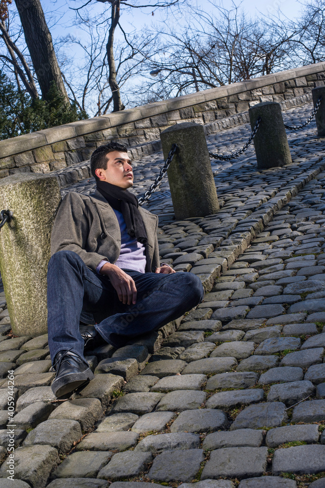 A young guy is lay on the ground, hopefully looking up.. A young guy is lay on the ground, hopefully looking up..