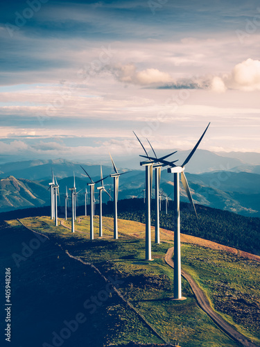 фотографія Vertical shot of the windmills in the wind farm