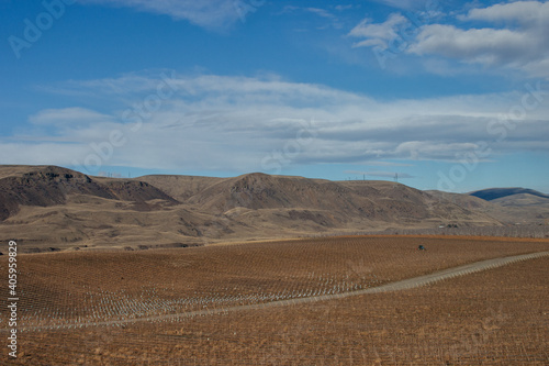 Beautiful autumn landscape with mountains on the horizon  blue sky with clouds and dry on the grass on the ground.