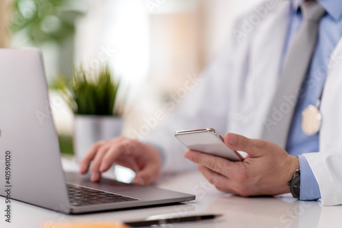 Doctor working on phone in the office