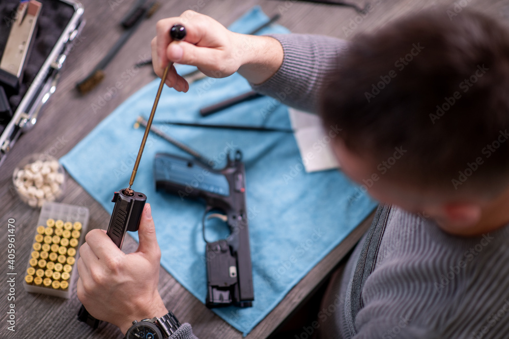 Man is cleaning handgun