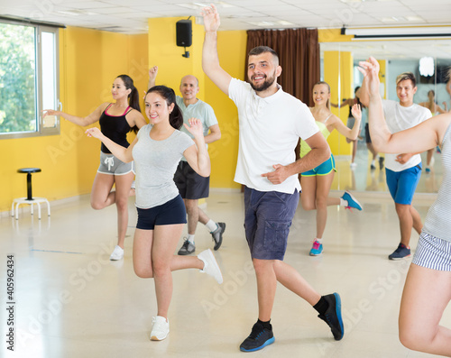 Dancing couples learning swing at dance class
