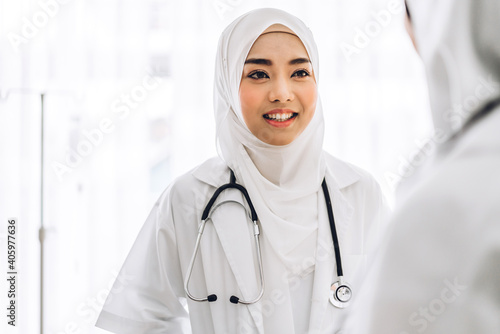 Professional medical two muslim asian woman doctor team with stethoscope in uniform working discussing and consulting talk in hospital.healthcare and medicine