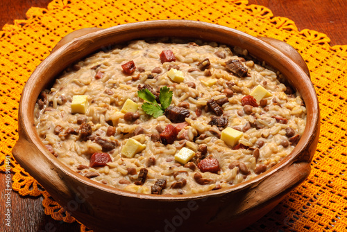 Rubacao, a traditional dish from the northeast of Brazil, made with beans, rice, sun-dried meat and rennet cheese, served in a clay bowl. Brazilian cuisine.