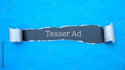 Teaser Ad. Blue torn paper banner with text label. Word in gray hole. photo