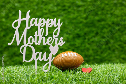 American football for Mother's Day with ball on green grass background photo