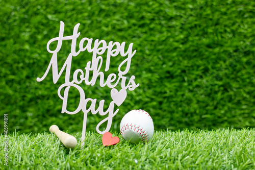 Baseball for mom on mother's day on green grass background