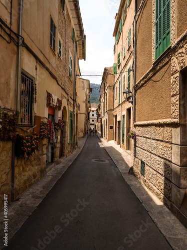 Old rustic mediterranean traditional house facade wall narrow alley lane road street Mallorca Balearic Islands Spain photo