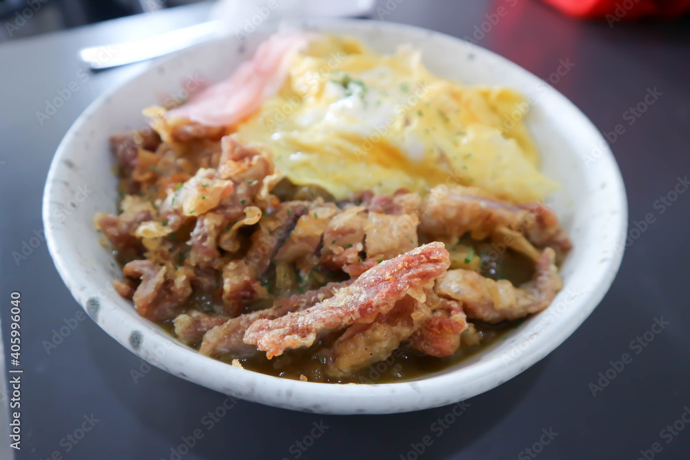 rice topped with fried pork and omelette and ginger rice topped with fried pork and omelette and ginger