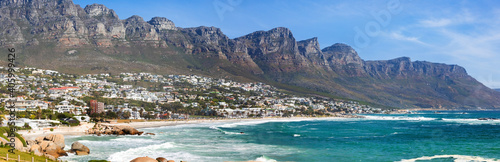 Urban waterfront town cityscape with a rocky mountain range behind in Cape Town, South Africa