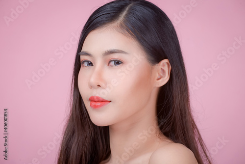Portrait of a woman using water to wash her face, Beauty Spa Woman with perfect skin Portrait. Asian beautiful woman skin makeup young model,on pink studio 