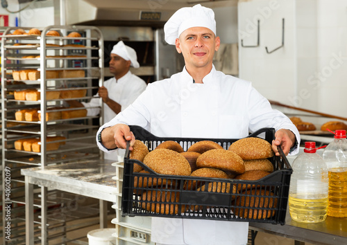 Portrait of baker with fresh bread at the bakery