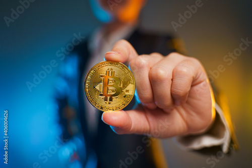 Close up shot of Business woman holding golden coin.