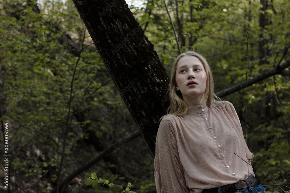 Portrait of a beautiful mysterious woman with blond hair in the forest. like a fairytale. Warm tone
Portrait of a beautiful mysterious woman with blond hair in the forest. like a fairytale. Warm tone