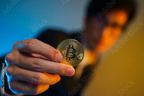 Close up shot of Businessman holding golden coin.
