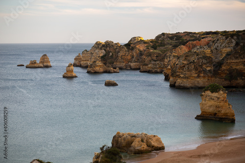 Mesmerizing view of the rocky cliffs on the wavy ocean under the cloudy sky in Portug photo