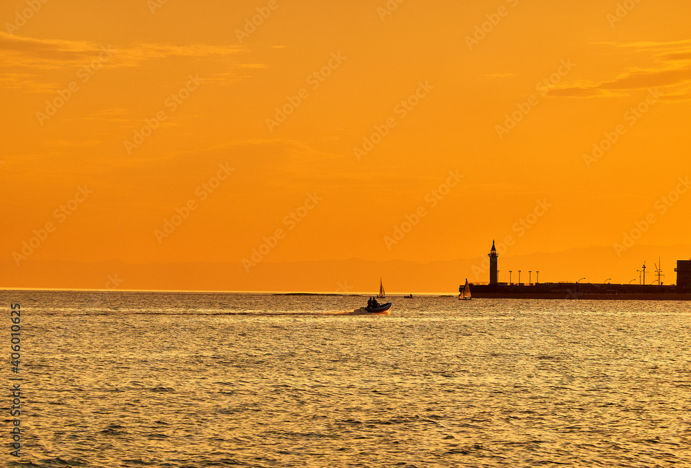 Silhouette Sailboats In Sea Against Orange Sky